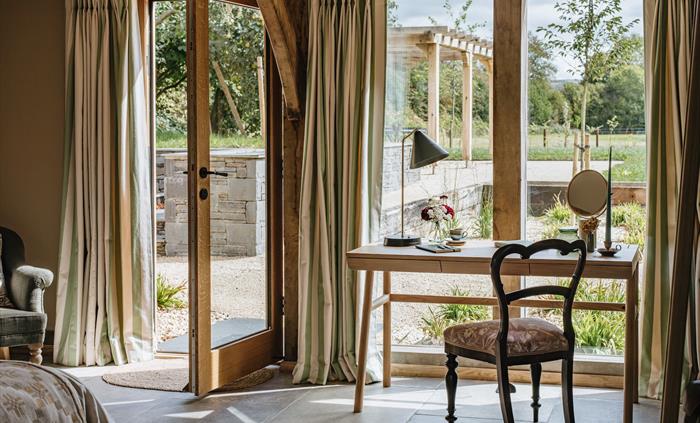 A desk and chair overlooking the countryside